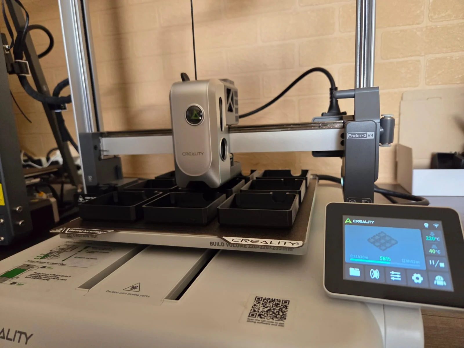 Close-up of a 3D printer nozzle laying down a fresh layer of filament on a printed object